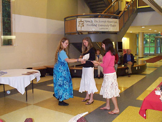 Stephanie Hohler and Jessica Cataldo receive their certificates from Professor Linda Henkel