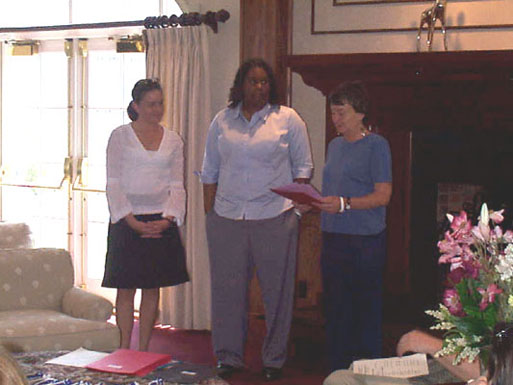 JoAnn Paradis Ornelas and Erica Sabella are awarded certificates and cords by Dr. Betsy Gardner for their research in psychology.  