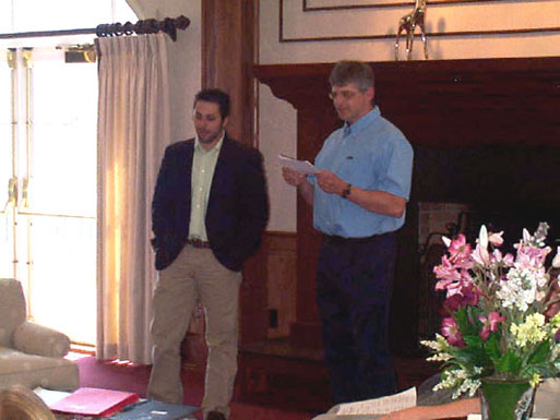 Jon Velotta listens as Dr. Glenn Sauer reads a message from his professor, Dr. Brian Walker, who could not attend the event.  