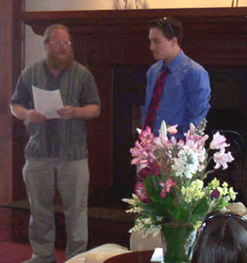 Dr. Kraig Steffen awards Michael Shinall for his research in chemistry.  